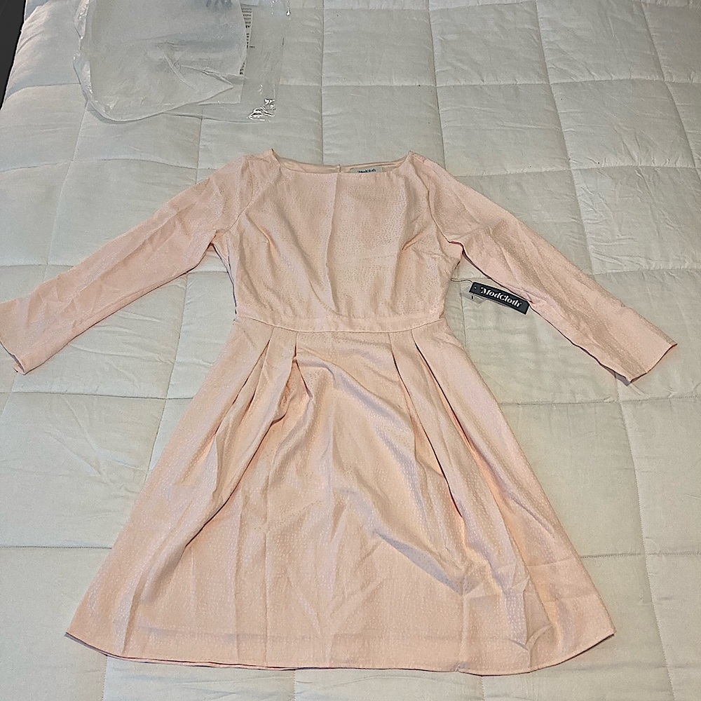 Women’s light pink quarter sleeve fit and flare dress. About knee length